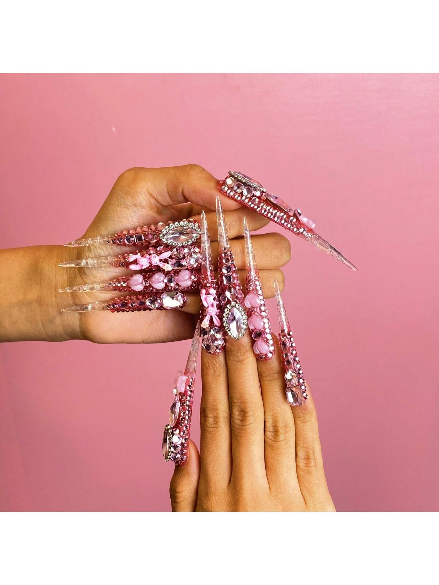 Handmade Press On Nails Medium Long Stiletto Pink And Nude Nail Tips With Heart And Gemstone Embellishments. Delicately Crafted For A Sweet And Glamorous Look. Handcrafted Nail Art For Party Nails, Wedding Nails, Daily Wear Nails, Holiday Nails. Easy To A